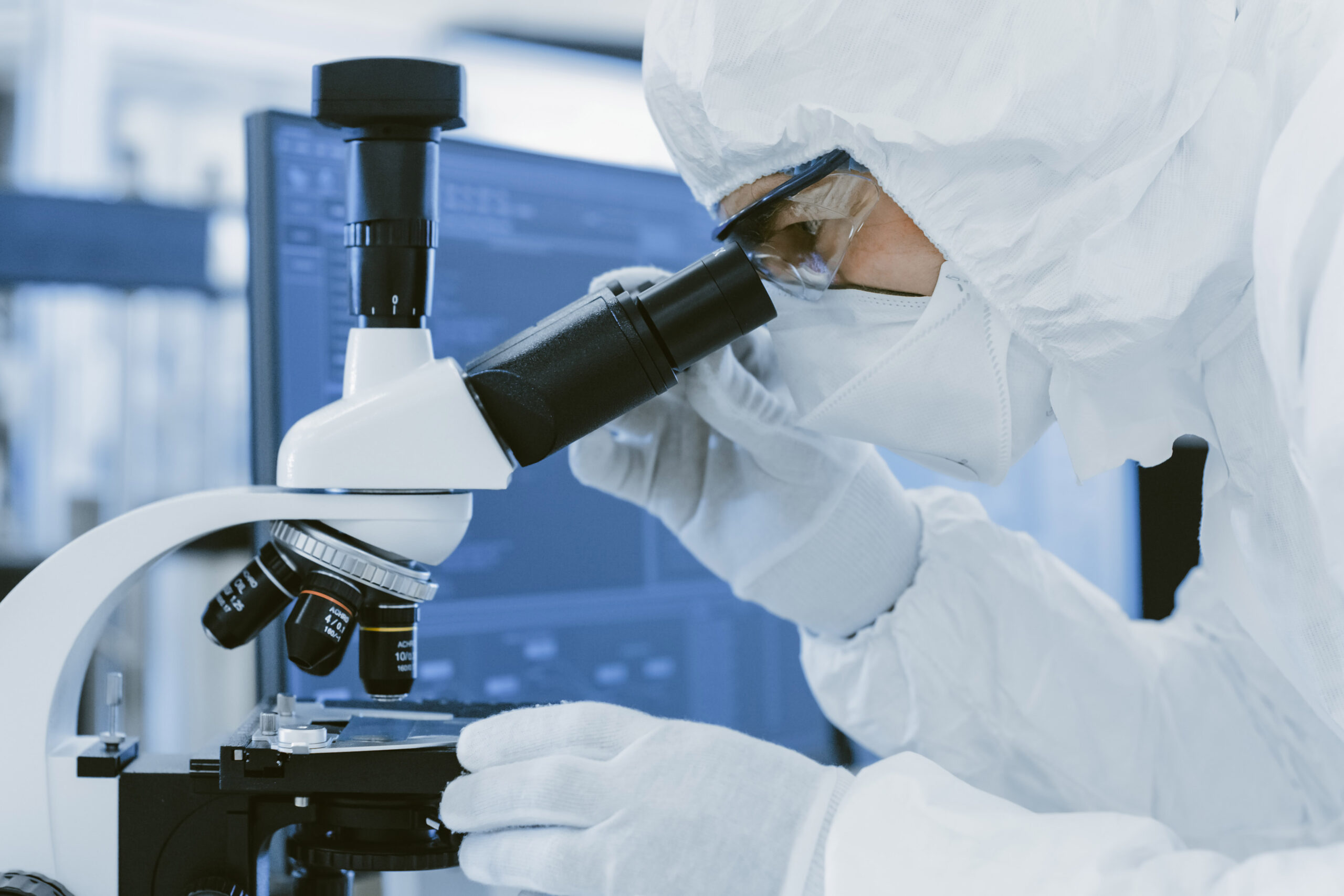 Close-up Shoy of a Scientist in Protective Clothes Doing Researc